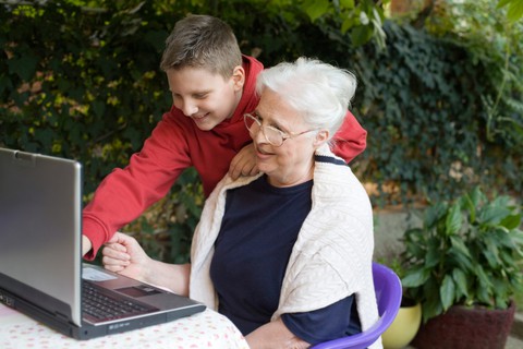 A grandmother and grandson working together on a PC laptop, perhaps even working on a movie making project. Image by Sandra Dragolovic.