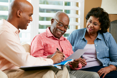 Couple talking to a tax specialist, an expert it's important to talk to before retiring.