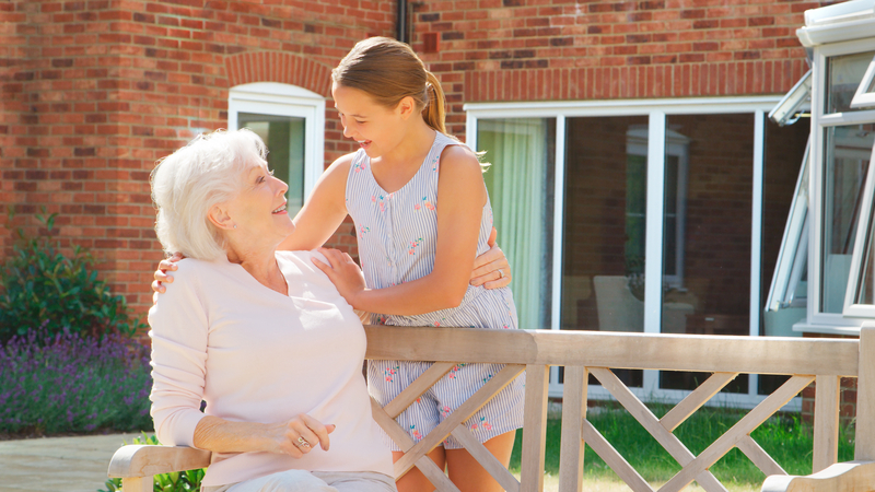 A girl visiting her grandmother at a retirement center, for article on using a Life Insurance Policy to Pay for Senior Living. Image by monkey business images