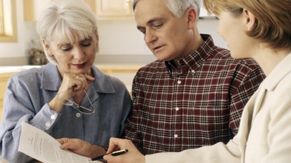 Couple working with a professional to disinherit someone from your will.