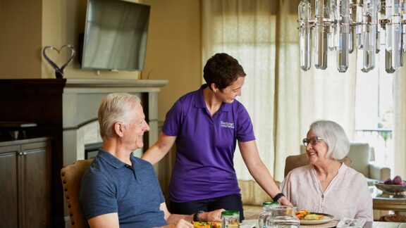 Touching Hearts at Home Caregiver with senior couple