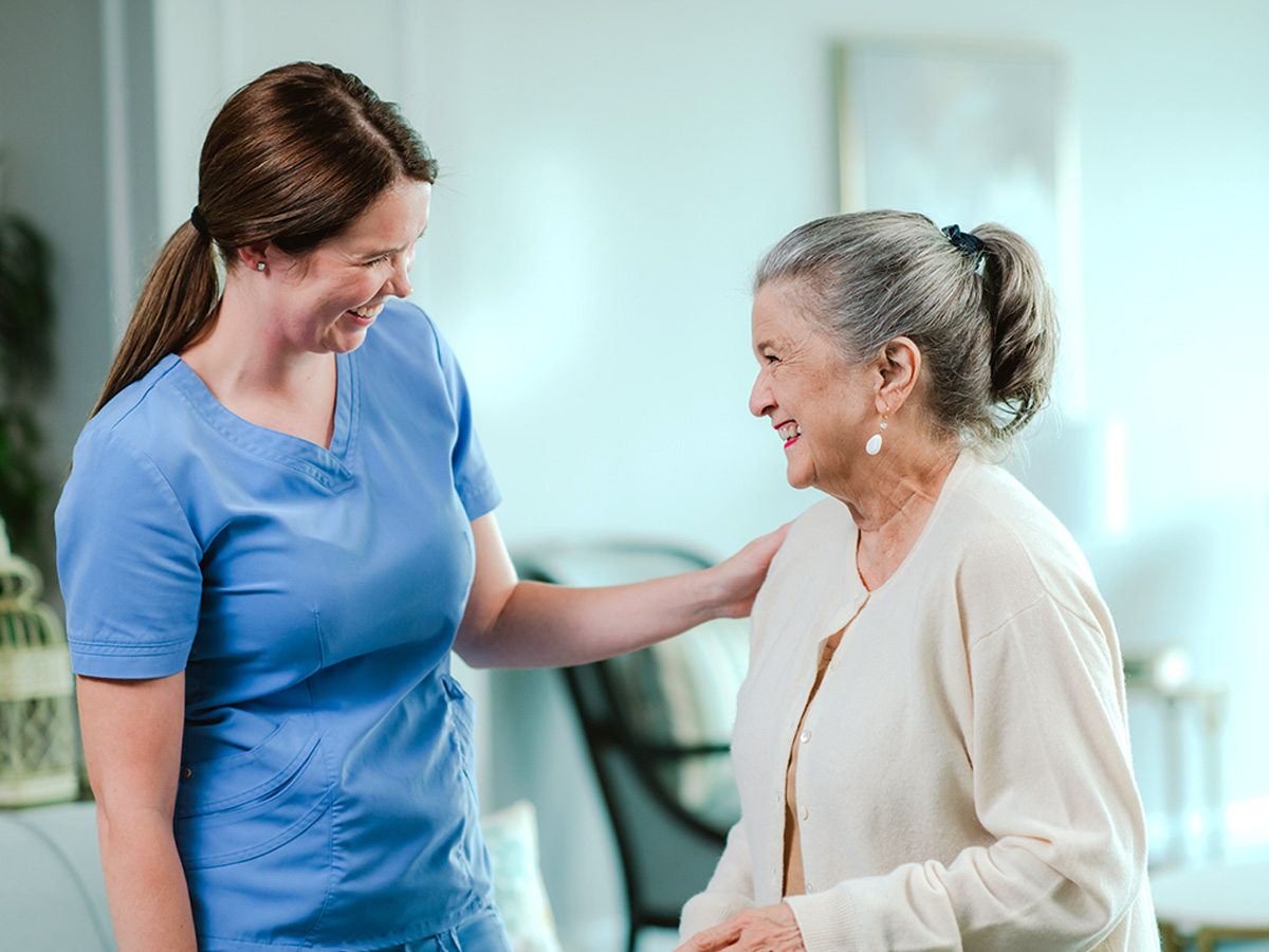 Three Rivers Health and Rehabilitation Center Happy Senior Lady Smiling with Caregiver