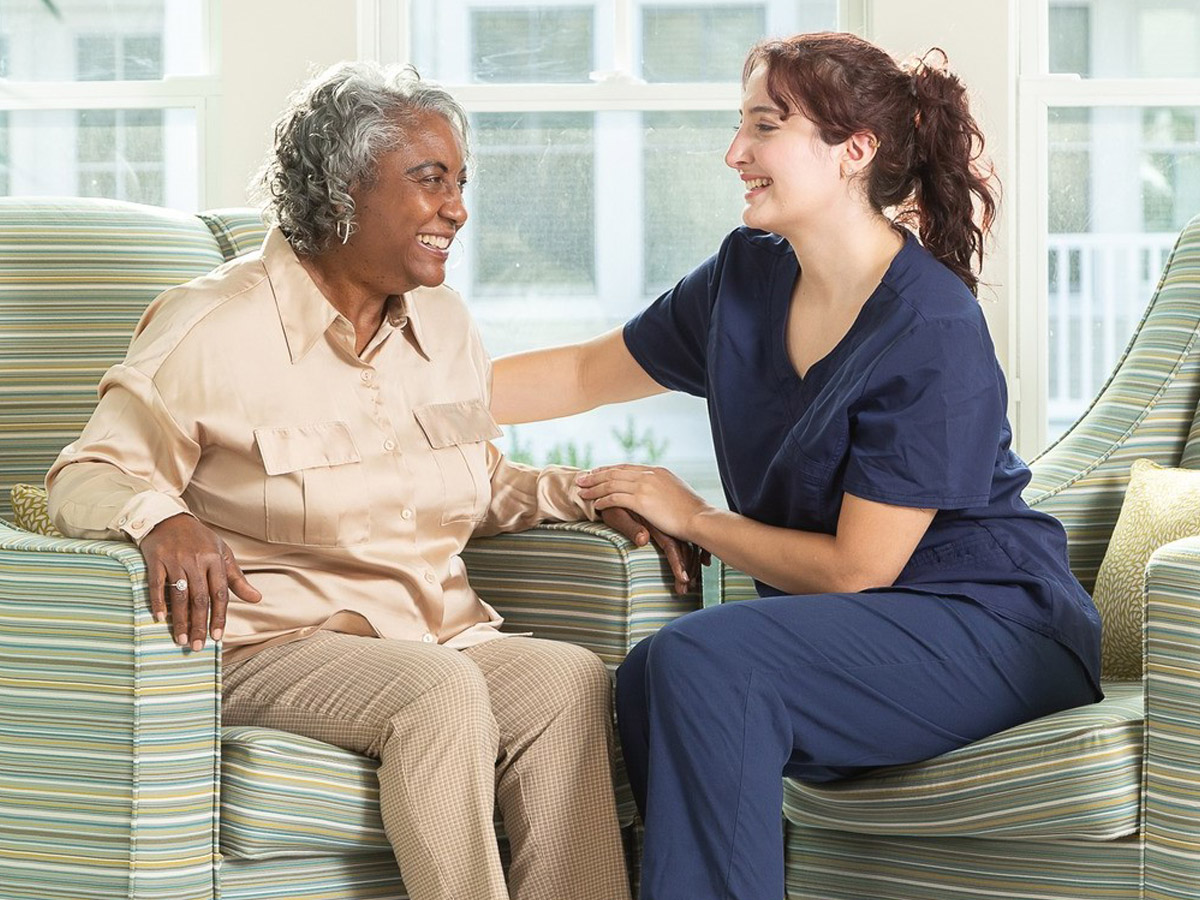 Woodlands Nursing and Rehabilitation Center Happy Senior Lady Sitting with Caregiver