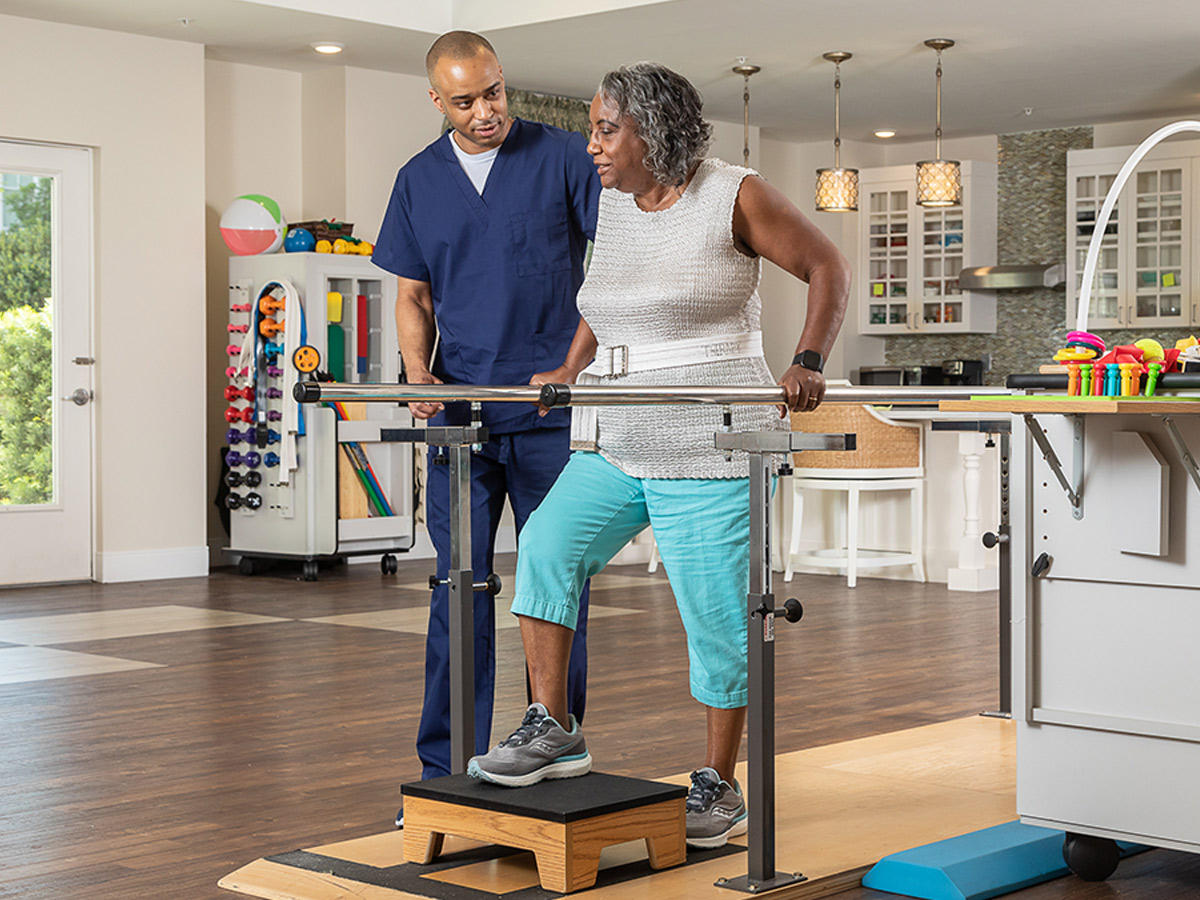 Woodlands Nursing and Rehabilitation Center Senior Lady with Caregiver Rehab Walking