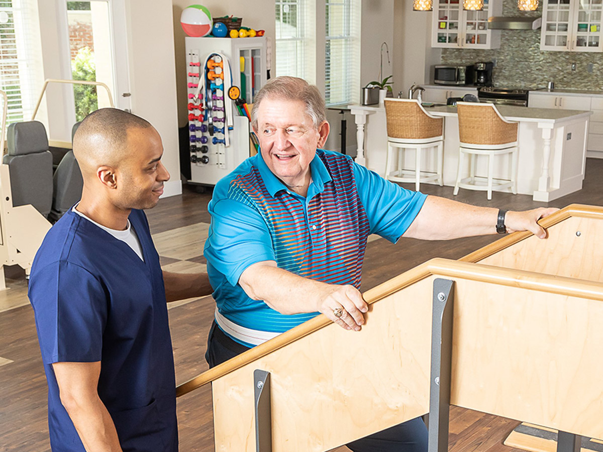 Woodlands Nursing and Rehabilitation Center Senior Man with Caregiver Rehab Stairs