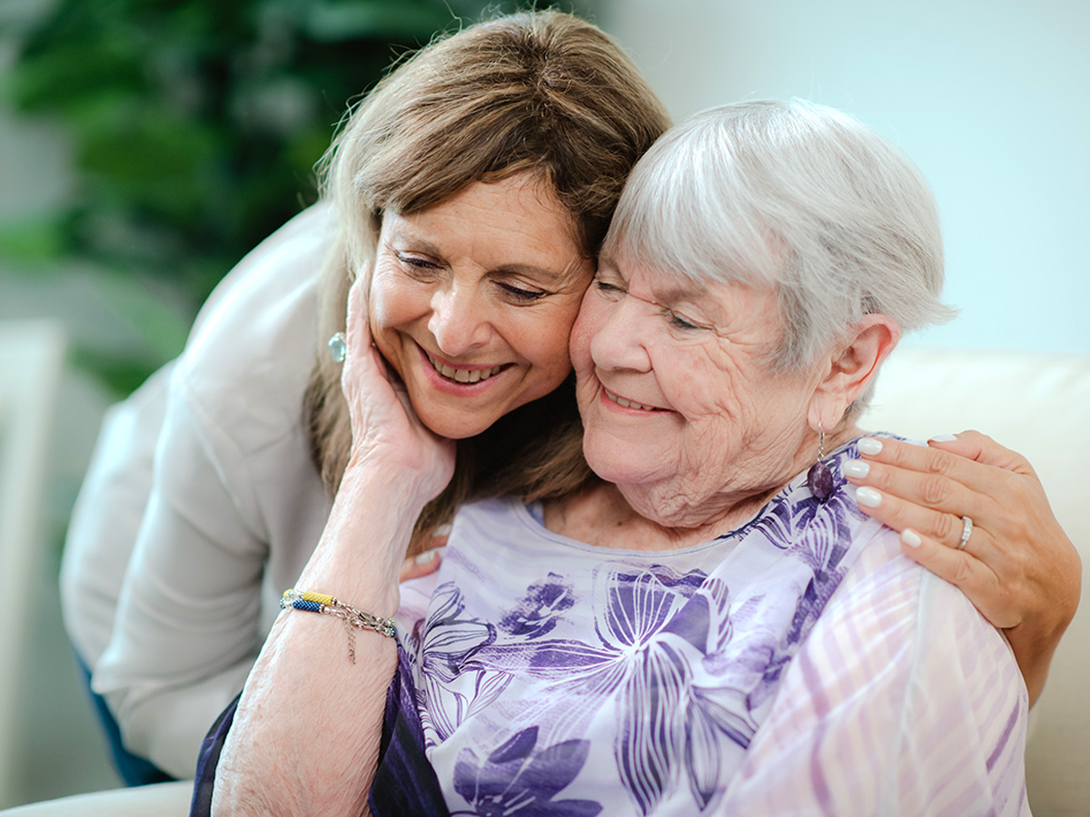 Bermuda Commons Nursing and Rehabilitation Center Senior Lady Hugging Caregiver
