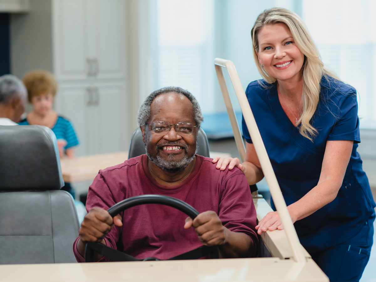 Bermuda Commons Nursing and Rehabilitation Center Senior Man with Caregiver Driving Model Car