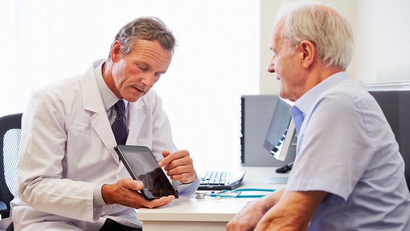 A doctor showing man he's been diagnosed with kidney disease.