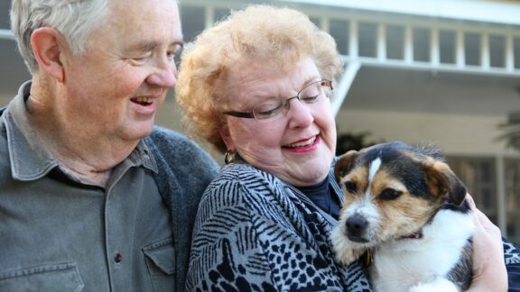 A couple with their beloved dog, who that assisted living facilities do allow pets. By Stephen Coburn