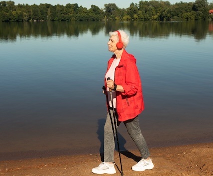 Woman walking along a lake