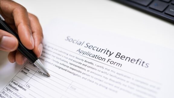 Someone signing social security form