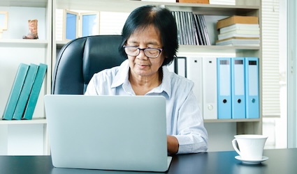 Woman on laptop applying for social security.