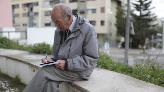 We still matter as we age: an elderly man writes in his journal. Image by Konstantin Shishkin