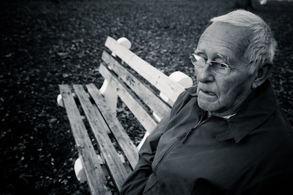 A man lonely on a bench after his gray divorce.