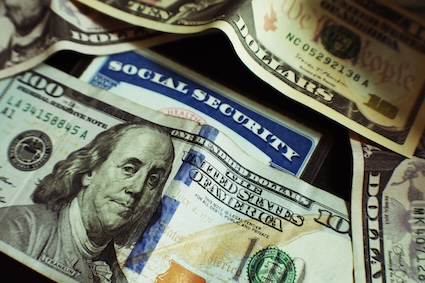 a ten dollar bill over a social security card.