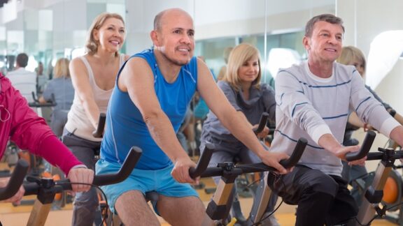 Group of seniors exercising together, a way of protecting brain health. By Tatsiana Yatsevich