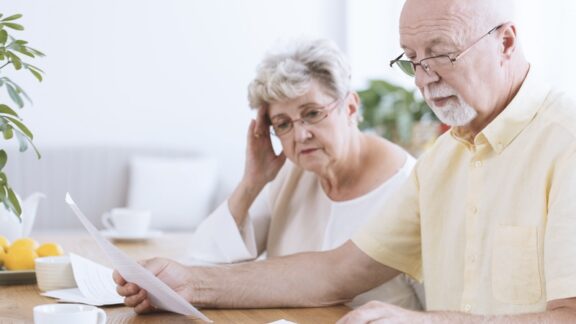 Couple looking at computer and papers planning their estate.