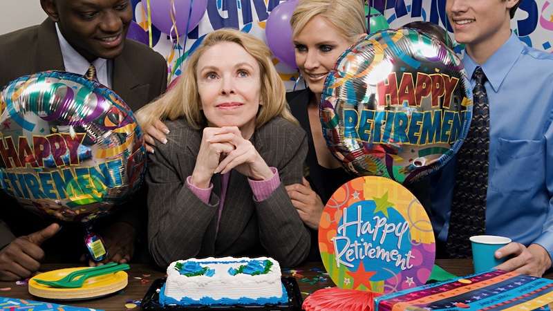 Retirement party with a lot of balloons and a woman going to retire at age 65