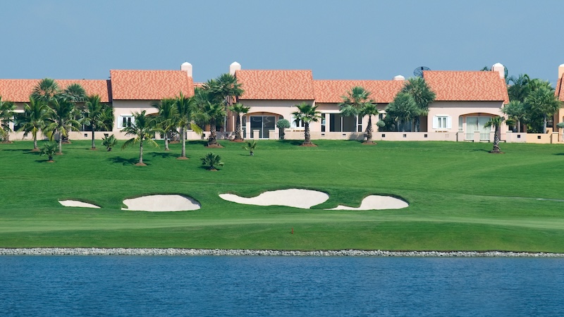 Florida homes on a golf course, with a waterway in the foreground. Image by Thor Jorgen Udvang. Article on why do people retire in Florida?