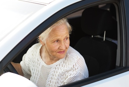 A senior woman about to drive looking nervous