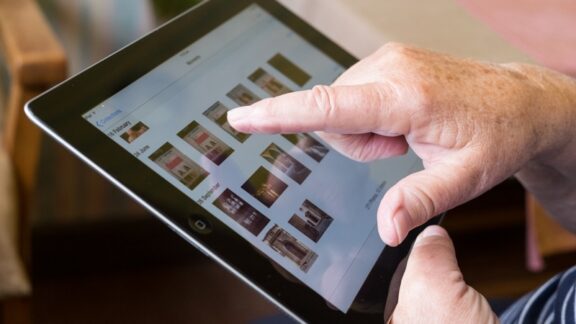 Senior using an iPad covered by AppleCare One.