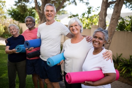 Friends at an active adult community after a yoga class. If not all are 55, they may wonder if someone must be 55 years old to live in a 55+ community.