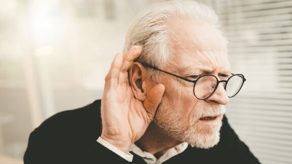 A man struggling to hear. A demonstration of how not wearing hearing aids can affect relationships.