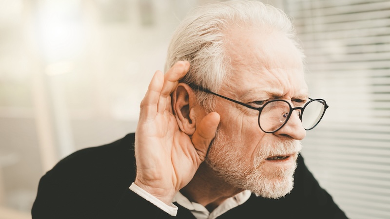 A man struggling to hear. A demonstration of how not wearing hearing aids can affect relationships.