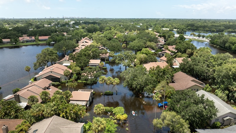 A neighborhood overwhelmed with flood water, showing the importance of knowing how to use medicare advantage in a disaster.