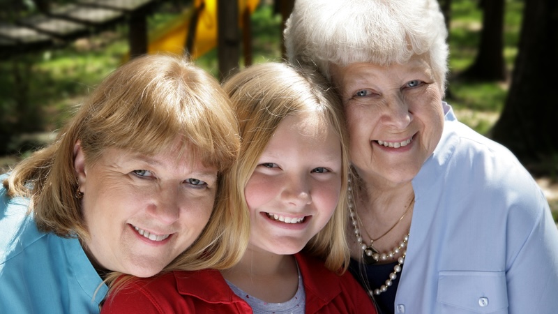 Three ladies together with differing ages representing multiple generations.