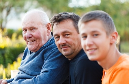 Three men smiling next to each other representing multiple generations.