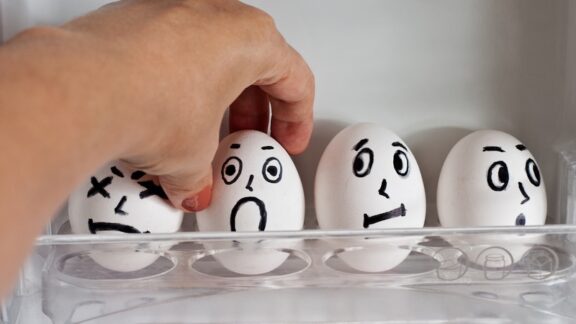 Eggs with expressions painted on them, as one is getting chosen to get cracked and used. Example of death humor. By Tomozina1