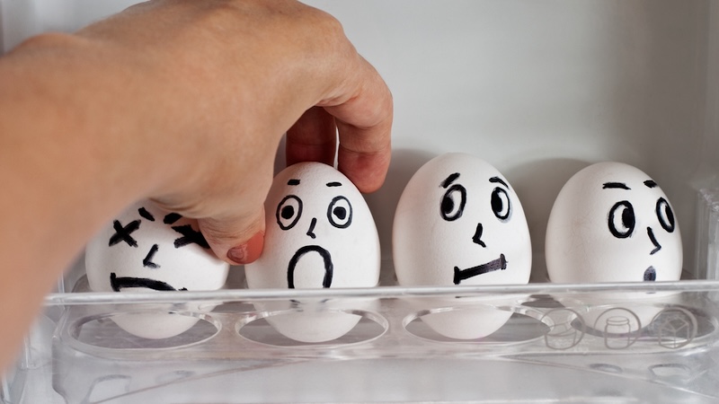 Eggs with expressions painted on them, as one is getting chosen to get cracked and used. Example of death humor. By Tomozina1