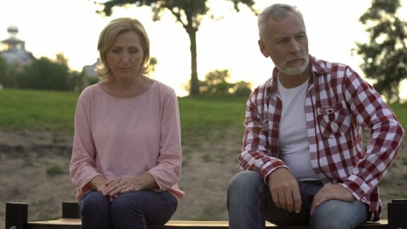 A fighting couple on a bench. By motortion. Representing a friend's new husband who is controlling her.