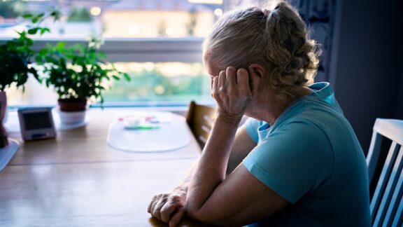 Sad woman experiencing Alzheimer's and isolation and loneliness.