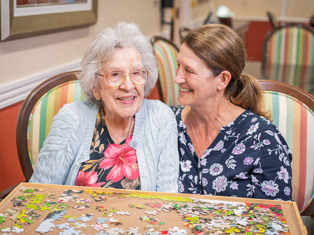 Marian Manor Senior Lady with Caregiver Building Puzzle