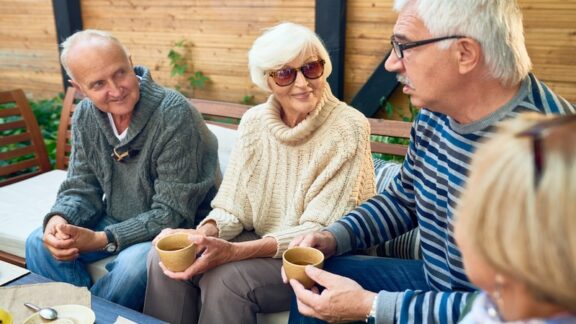 A group discussion at a cohousing community for seniors. Image by seventyfourimages.
