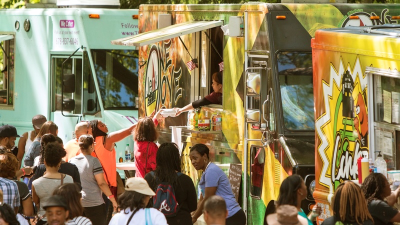 person getting food wanting to eat from a food truck.