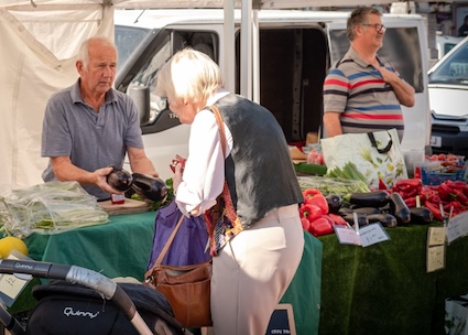 woman buying produce from farmers market
