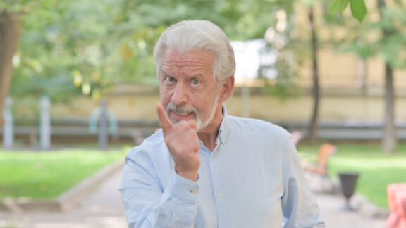 A man in a grumpy mood pointing angrily at you!