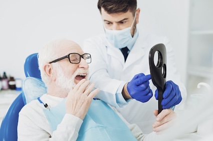 Man at the dentist knowing the benefits of taking care of his mouth outweighs the dental costs