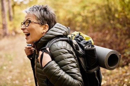 A senior woman on a hiking adventures, taking it upon herself for making dreams come true.
