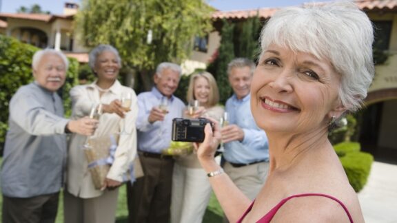 Old friends at a party, for article on what to wear to a class reunion. Image by photographerlondon
