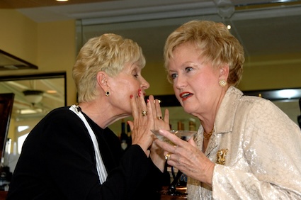 Two women gossiping at their class reunion. Image by Mary Katherine Wynn.