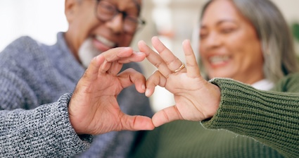 Woman making heart shape with hands with a serial cheater
