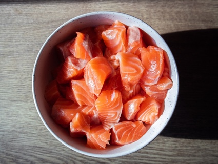 Cubed salmon ready for a salmon and broccoli recipe