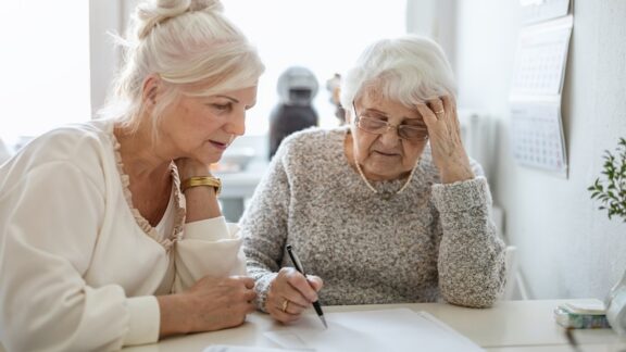 Women figuring out finances as daughter starts financial caregiving.