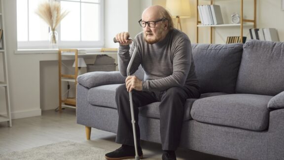 Lonely man at home, suffering from the incontinence and loneliness link. Image by Lacheev