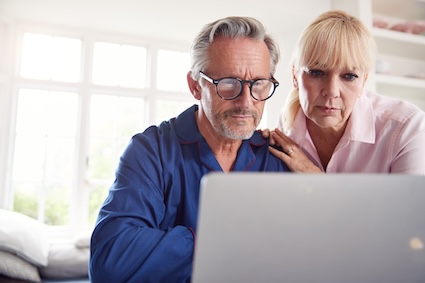 Couple looking at computer concerned.