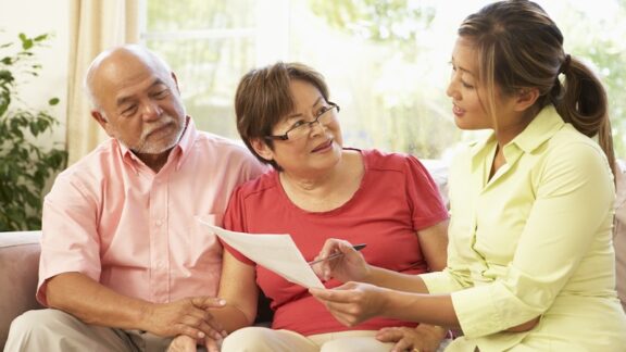A woman helping a couple plan and avoid probate.